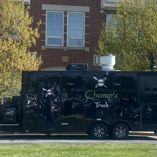 a black truck with a skull and crossbones on the side