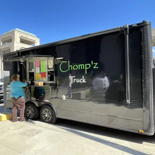 a woman standing in front of a truck