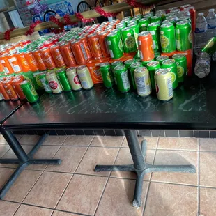 a table full of cans of soda