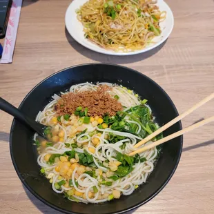 a bowl of noodles and chopsticks