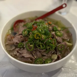 a bowl of soup with meat and vegetables