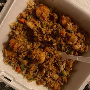 a close up of a takeout container with a spoon in it