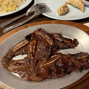 a plate of ribs and noodles