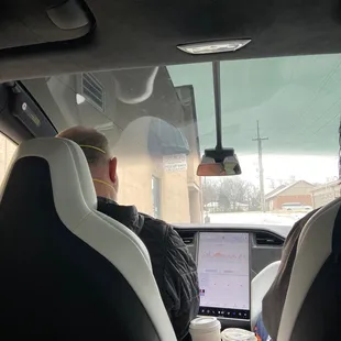 two people sitting in a car