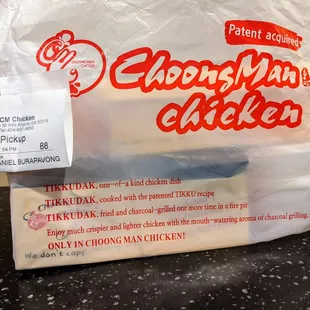 Takeout bag with Choong Man Chicken branding and marketing language.