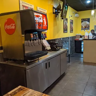 Inside. Order and pickup counter. Self-serve fountain drink machine, napkins, etc. to left. Thank you, Christina.