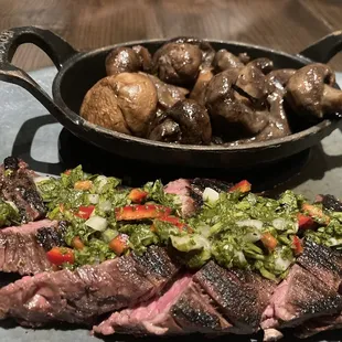 Hanger with chimichurri cooked Pittsburgh style, medium rare. Side of sautéed cremini mushrooms