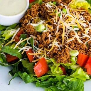 Taco Salad, ground turkey, romaine, tomatoes, cheese, green onions, avocado-lime dressing