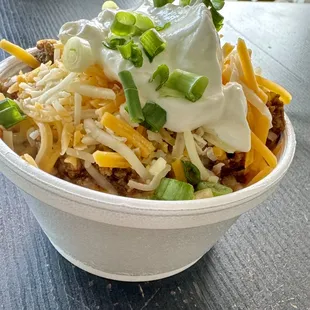 8 ounce chili bowl, topped with cheese, sour cream and green onions