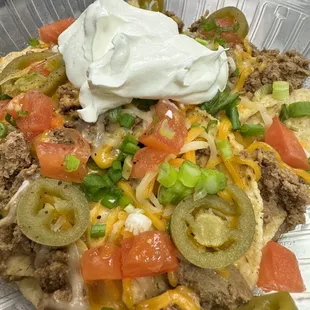 Chop Nachos- tortilla chips topped with chili, cheese, tomatoes, green onions, jalapeños, sour cream