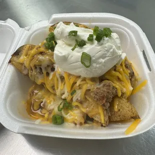 Loaded wedges, fresh not frozen, baked not fried potato wedges topped with chili, cheese, sour cream and green onions