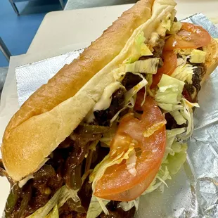 Veggie Chop - sauté bell peppers, onions and mushrooms, cheese, lettuce and tomatoes on a toasted hoagie