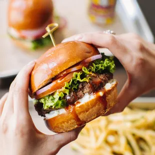 Buffalo Burger-Spicy homemade wing sauce, blue cheese sauce, shaved red onion, vine ripened tomato, green leaf lettuce