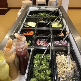 a salad bar with a variety of vegetables
