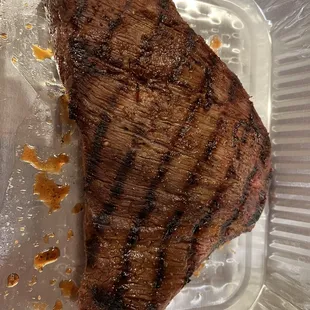 a steak in a plastic container