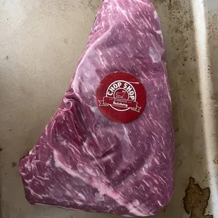 a piece of beef in a roasting pan