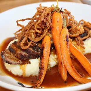 The 48 Hour Slow-Cooked Short Rib was made with Grilled Baby Carrots, Whipped Potatoes, Crispy Pickled Onions, &amp; 3 Peppercorn Demi-Glace.