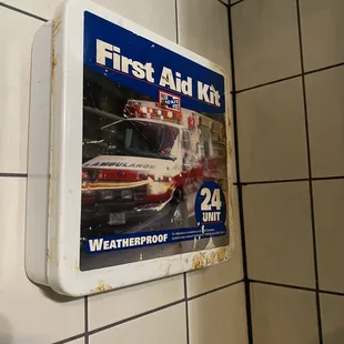 a first aid kit hanging on a wall