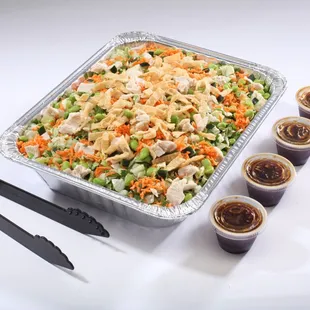 a tray of food and cups of sauce