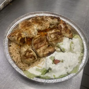 Chicken Kabab with Kabli Pulawi rice and white sauce with salad on the side.