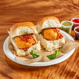 The dish consists of a deep fried potato dumpling placed inside a bread bun sliced almost in half through the middle.