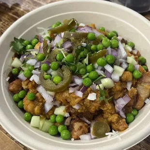 Chicken vindaloo rice bowl with toppings, vindaloo sauce is near the bottom and darker/spicy