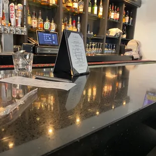 a bar with a menu on the counter