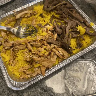 The feast (Yellow rice, chicken shawarma, steak shawarma, hummus)