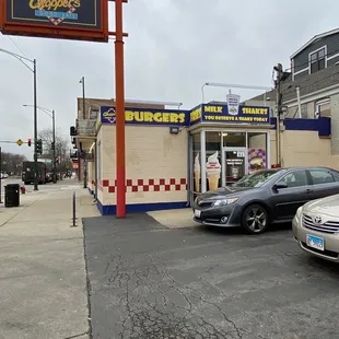 cars parked in front of a burger king restaurant