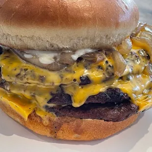 a hamburger with cheese and onions