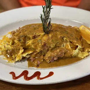 Menu Item:  Big Ol&apos; Pig Omelette  eggs, ham, bacon. sausage, peppers, cheese and topped with chipotle sauce