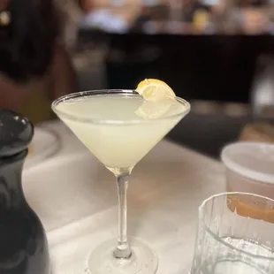 a martini with a lemon garnish