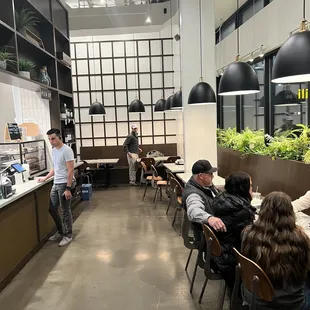 people sitting at tables in a restaurant