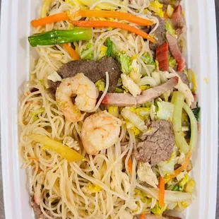 a plate of noodles with meat and vegetables