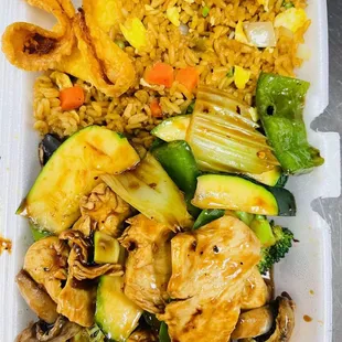 chicken, rice, and vegetables in a styrofoam container