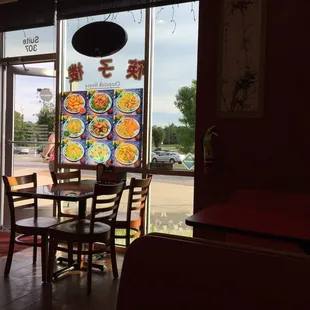 a table and chairs in front of a window