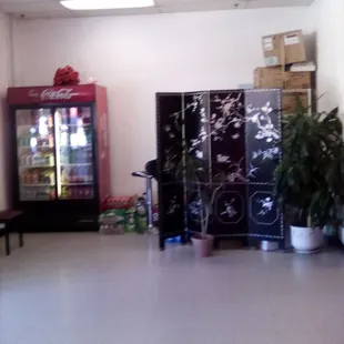 a room with a refrigerator and a table