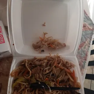 a takeout container with noodles and meat