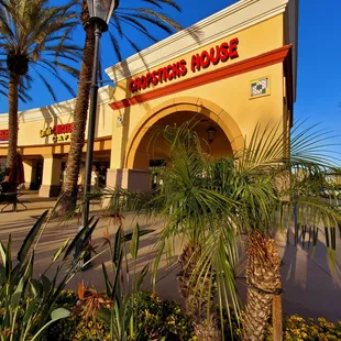 a palm tree in front of a restaurant