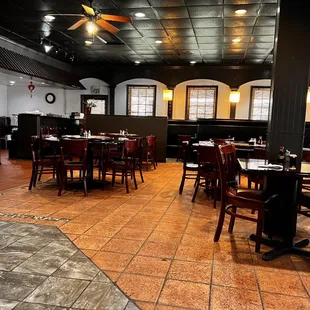 a dining area with tables and chairs