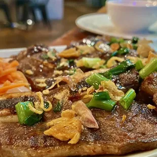 a plate of steak and vegetables