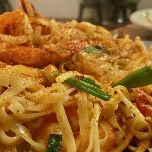 a plate of noodles and shrimp