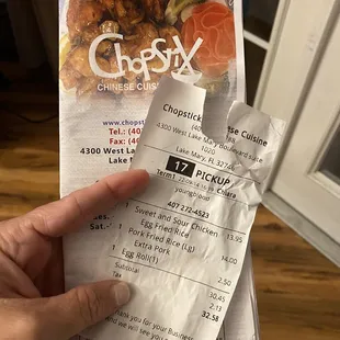 a hand holding a piece of paper