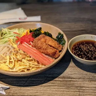 a bowl of noodles and a bowl of sauce