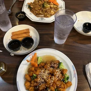 Sesame Chicken with a side of fried rice. Egg noodles with broccoli, onions and egg in a soy sauce