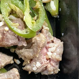 meat and peppers in a pan