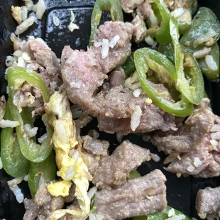 a close up of meat and vegetables in a pan