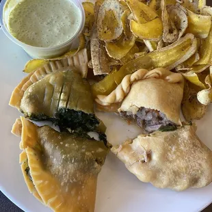 Spinach and pulled pork empanadas with ranch dill sauce and fried tostones.