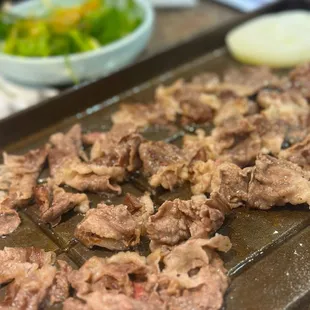 a tray of meat and vegetables
