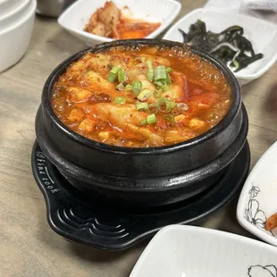 a bowl of hot and sour soup on a table